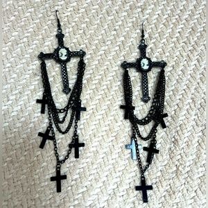 Black chandelier style earrings with crosses.